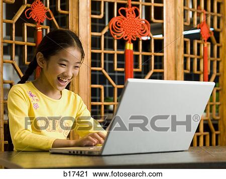 Girl sitting with laptop smiling View Large Photo Image Stock Image - Girl sitting with laptop smiling. Fotosearch