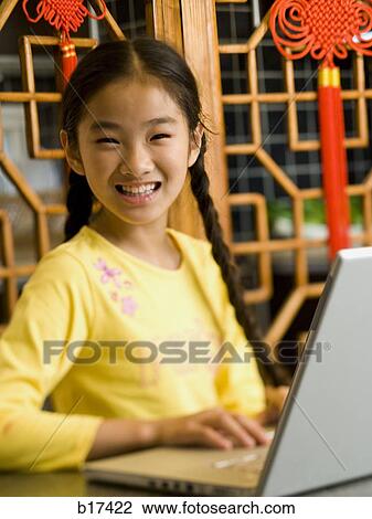 Girl sitting with laptop smiling View Large Photo Image Stock Image - Girl sitting with laptop smiling. Fotosearch