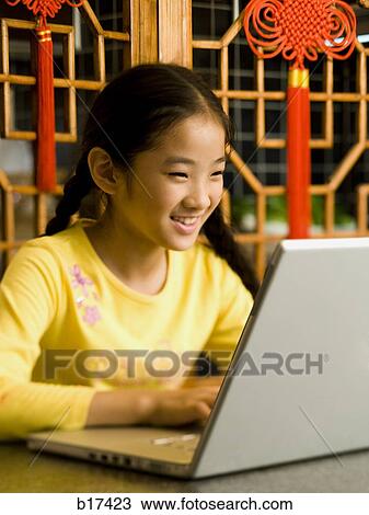Girl sitting with laptop smiling View Large Photo Image Stock Image - Girl sitting with laptop smiling. Fotosearch