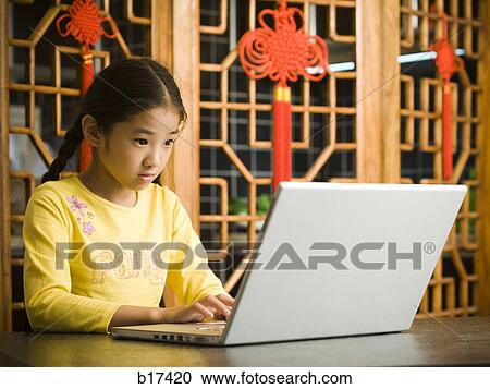 Stock Image - Girl sitting with laptop. Fotosearch