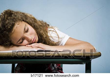 Girl sleeping at desk on workbook View Large Photo Image Stock Image - Girl sleeping at desk on workbook. Fotosearch