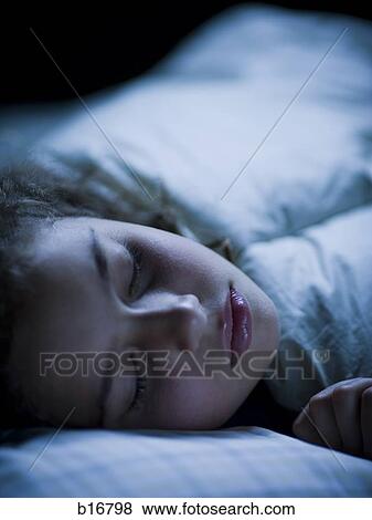 Stock Photo - Girl sleeping in bed. Fotosearch