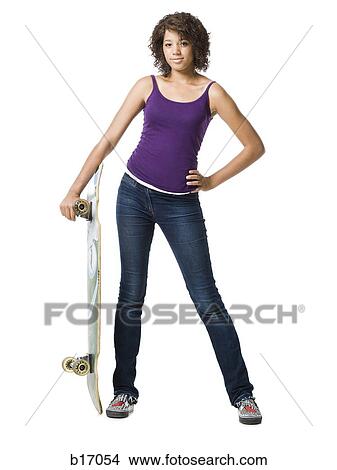 Girl standing and holding skateboard View Large Photo Image Picture - Girl standing and holding skateboard. Fotosearch