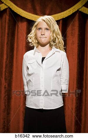 Girl standing on stage with lips pressed together View Large Photo Image Stock Image - Girl standing on stage with lips pressed together. Fotosearch