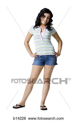 Girl standing with hands on hips smiling View Large Photo Image Stock Photo - Girl standing with hands on hips smiling. Fotosearch