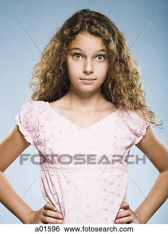 Stock Photograph - Girl standing with hands on hips. Fotosearch