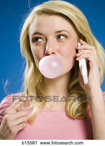Girl talking on cell phone and blowing bubble View Large Photo Image Stock Image - Girl talking on cell phone and blowing bubble. Fotosearch