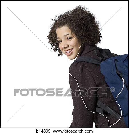 Girl with backpack and earbuds smiling with braces View Large Photo Image Stock Photo - Girl with backpack and earbuds smiling with braces. Fotosearch