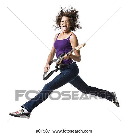 Girl with braces and guitar leaping and sticking tongue out View Large Photo Image Stock Photo - Girl with braces and guitar leaping and sticking tongue out. Fotosearch