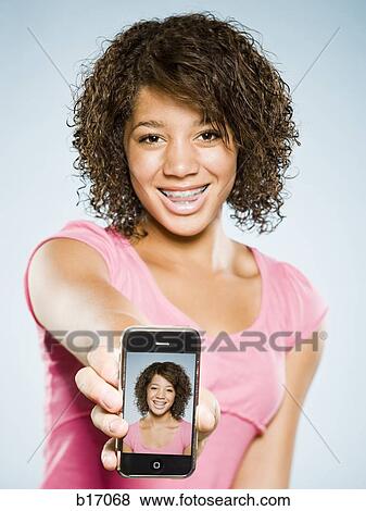 Girl with braces holding blackberry and smiling View Large Photo Image Stock Photo - Girl with braces holding blackberry and smiling. Fotosearch