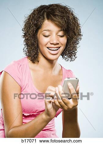 Girl with braces holding blackberry smiling View Large Photo Image Stock Image - Girl with braces holding blackberry smiling. Fotosearch