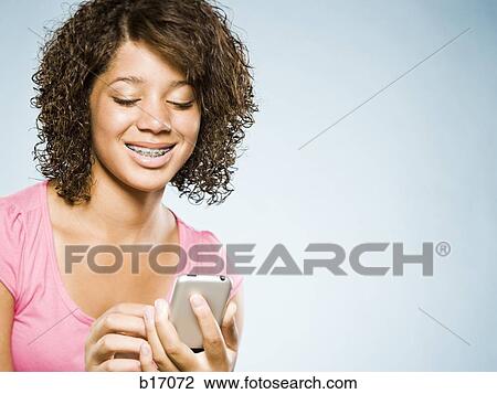 Girl with braces holding blackberry smiling View Large Photo Image Stock Image - Girl with braces holding blackberry smiling. Fotosearch