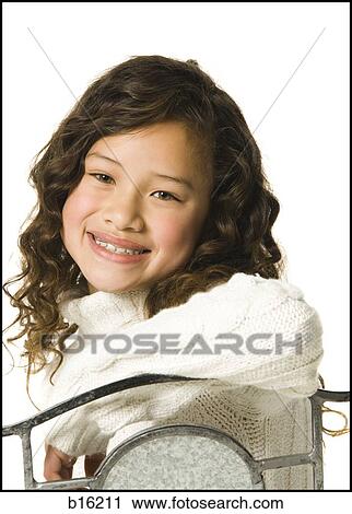 Girl with braces sitting in chair smiling View Large Photo Image Stock Image - Girl with braces sitting in chair smiling. Fotosearch