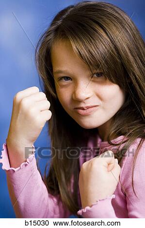 Girl with clenched fists smiling View Large Photo Image Stock Image - Girl with clenched fists smiling. Fotosearch