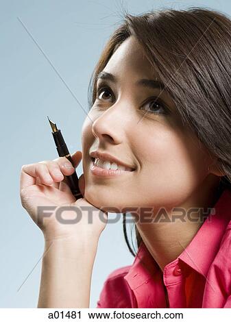 Girl with fountain pen smiling View Large Photo Image Stock Image - Girl with fountain pen smiling. Fotosearch