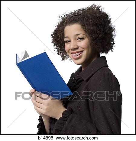 Girl with hardcover book and braces smiling View Large Photo Image Stock Photo - Girl with hardcover book and braces smiling. Fotosearch