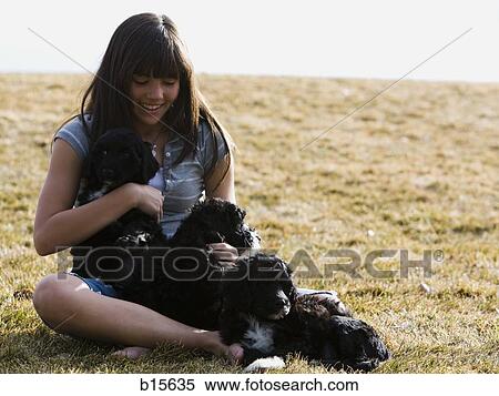Girl with puppies outdoors smiling View Large Photo Image Stock Photography - Girl with puppies outdoors smiling. Fotosearch