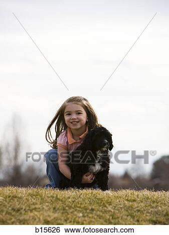 Girl with puppy outdoors View Large Photo Image Stock Photograph - Girl with puppy outdoors. Fotosearch