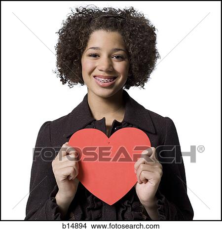 Girl with red heart View Large Photo Image Picture - Girl with red heart. Fotosearch