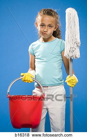 Girl with rubber gloves holding mop and bucket frowning View Large Photo Image Stock Photo - Girl with rubber gloves holding mop and bucket frowning. Fotosearch