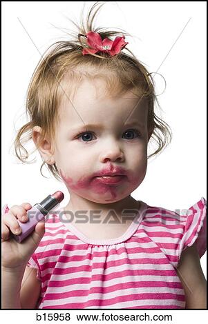 Girl with tube of lipstick and lipstick on face View Large Photo Image Stock Photo - Girl with tube of lipstick and lipstick on face. Fotosearch