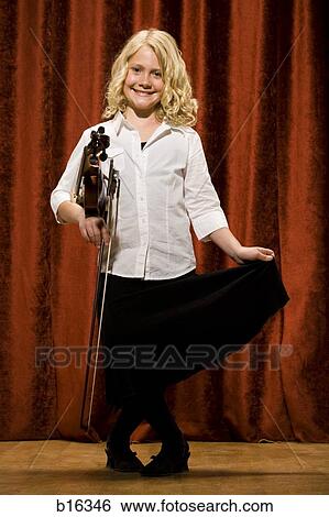 Stock Photograph - Girl with violin smiling and curtsying. Fotosearch