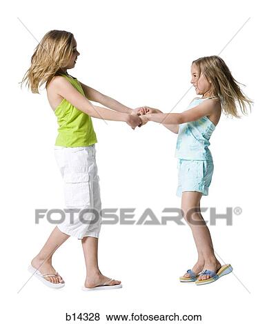 Stock Photo - Girls dancing and holding hands. Fotosearch