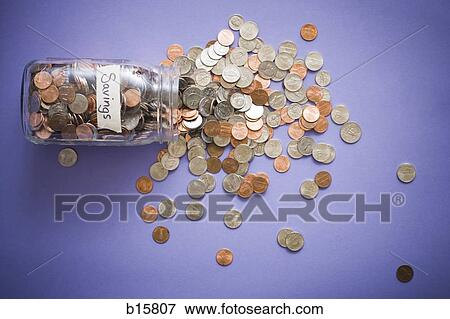 Glass jar with coins and Savings label and scattered coins View Large Photo Image Stock Photo - Glass jar with coins and Savings label and scattered coins. Fotosearch