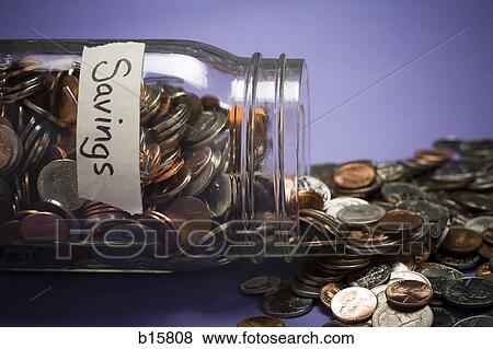 Glass jar with coins and Savings label and scattered coins View Large Photo Image Stock Photo - Glass jar with coins and Savings label and scattered coins. Fotosearch