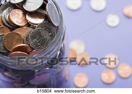 Glass jar with coins and scattered coins View Large Photo Image Picture - Glass jar with coins and scattered coins. Fotosearch