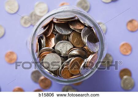 Glass jar with coins and scattered coins View Large Photo Image Stock Photograph - Glass jar with coins and scattered coins. Fotosearch