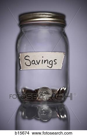 Glass jar with Savings label and change View Large Photo Image Picture - Glass jar with Savings label and change. Fotosearch