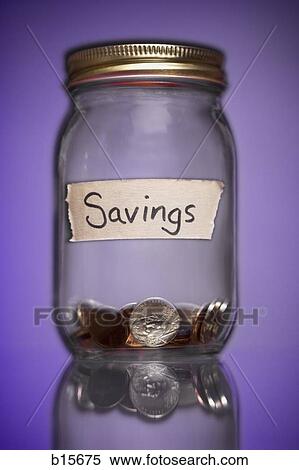 Glass jar with Savings label and change View Large Photo Image Stock Photography - Glass jar with Savings label and change. Fotosearch