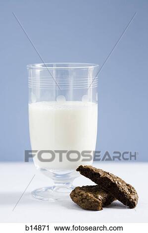Stock Image - Glass of milk with chocolate cookie. Fotosearch