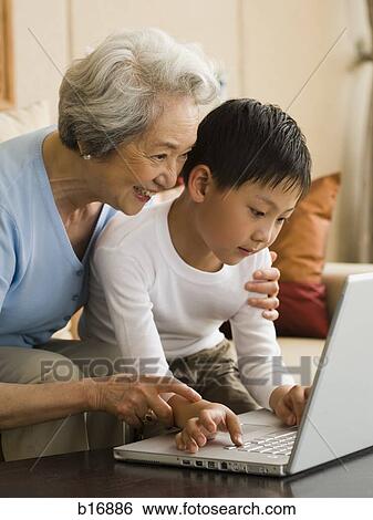 Grandmother and grandson with laptop View Large Photo Image Stock Photograph - Grandmother and grandson with laptop. Fotosearch