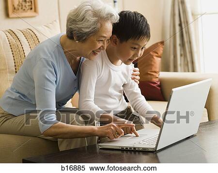 Stock Photography - Grandmother and grandson with laptop. Fotosearch