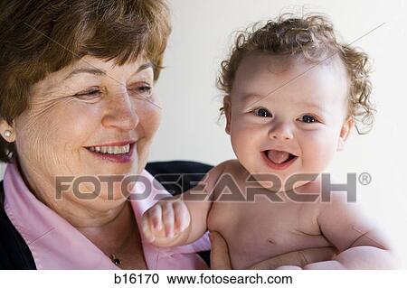 Grandmother holding baby smiling View Large Photo Image Stock Image - Grandmother holding baby smiling. Fotosearch