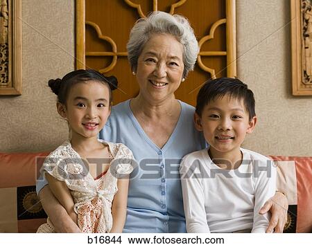 Picture - Grandmother with granddaughter and grandson smiling. Fotosearch