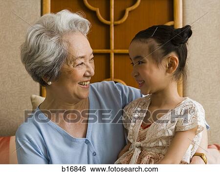 Grandmother with granddaughter smiling View Large Photo Image Stock Photograph - Grandmother with granddaughter smiling. Fotosearch