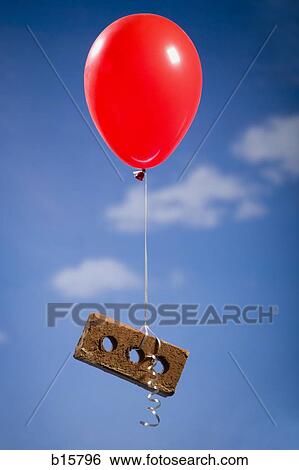 Helium balloon lifting brick outdoors View Large Photo Image Stock Photograph - Helium balloon lifting brick outdoors. Fotosearch