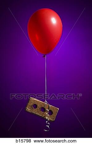 Stock Photo - Helium balloon lifting brick. Fotosearch
