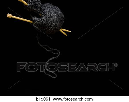 Stock Image - Knitting needles with black yarn. Fotosearch