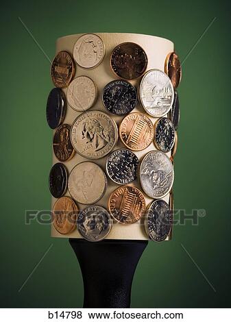 Stock Photo - Lint roller with coins. Fotosearch