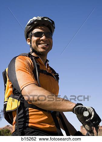 Male cyclist with helmet outdoors smiling View Large Photo Image Stock Image - Male cyclist with helmet outdoors smiling. Fotosearch