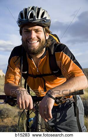 Male cyclist with helmet outdoors smiling View Large Photo Image Stock Image - Male cyclist with helmet outdoors smiling. Fotosearch