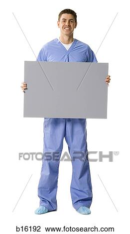 Male doctor or nurse holding blank sign smiling View Large Photo Image Stock Image - Male doctor or nurse holding blank sign smiling. Fotosearch