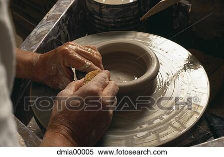 Stock Photography - Male hands with pottery wheel and sponge. Fotosearch