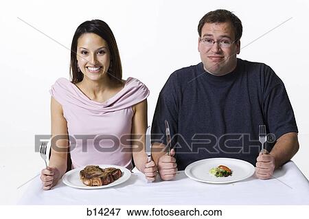 Man and Woman eating View Large Photo Image Stock Photo - Man and Woman eating. Fotosearch