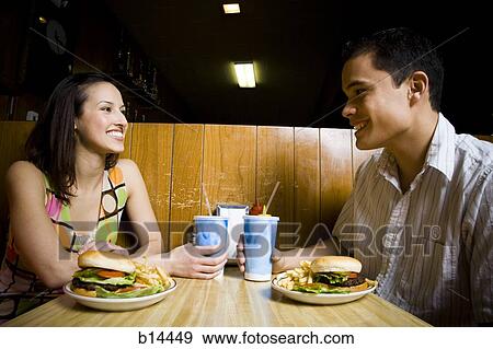 Stock Photo - Man and Woman eating. Fotosearch