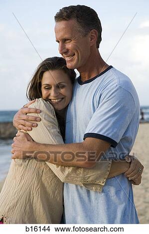 Man and woman hugging on beach View Large Photo Image Picture - Man and woman hugging on beach. Fotosearch